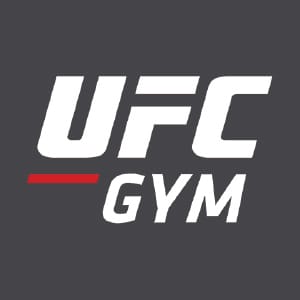 UFC Gym logo with bold white lettering and red underline accent on dark gray background