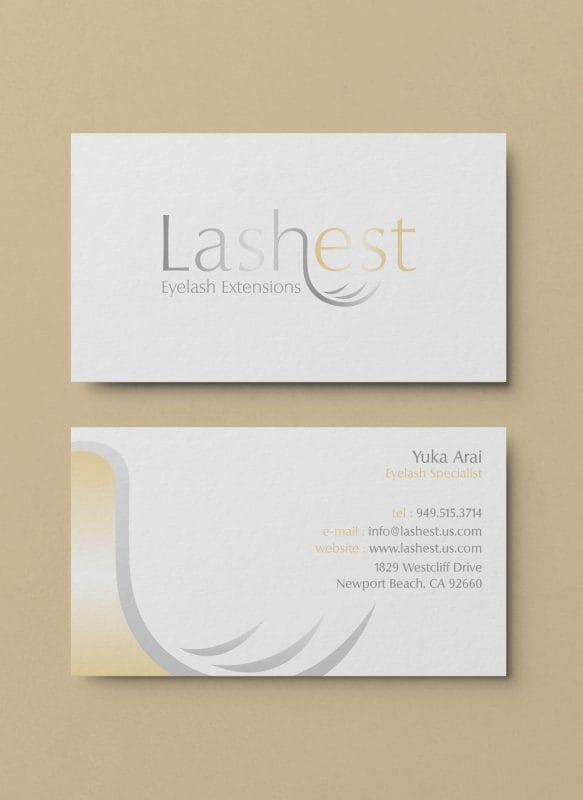 Lashest eyelash extensions logo and business card design featuring soft gray and gold typography with a curved lash motif.