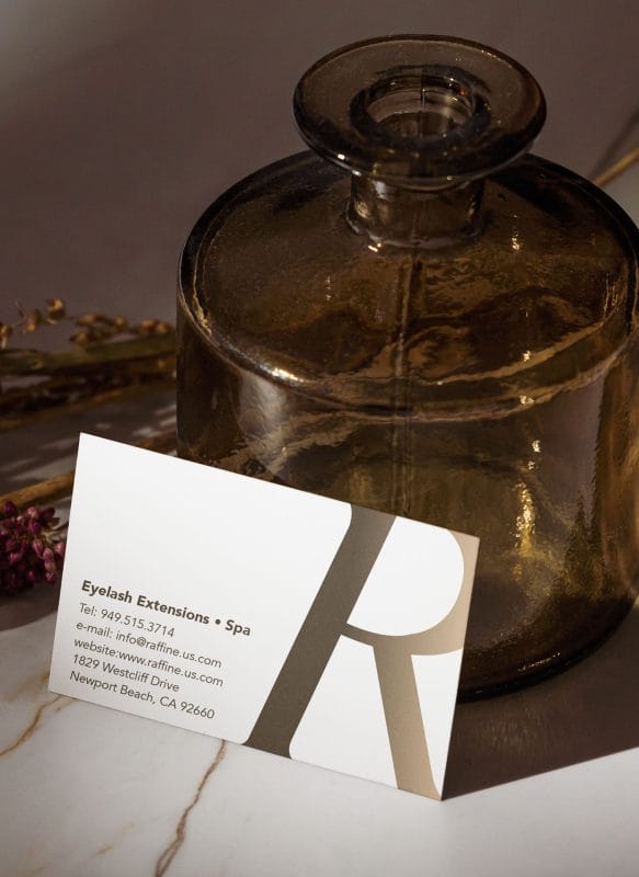 Raffine spa business card displayed in lifestyle setting with warm neutral tones