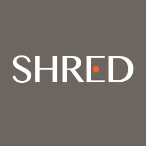 Modern SHRED supplement logo featuring minimalist white typography with an orange dot accent on a dark gray background