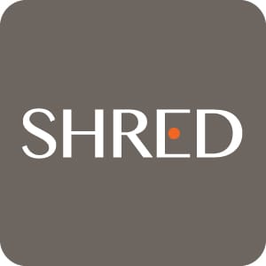 Large modern SHRED supplement logo featuring minimalist white typography with an orange dot accent on a dark gray background
