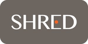 Small modern SHRED supplement logo featuring minimalist white typography with an orange dot accent on a dark gray background